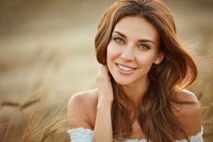 beautiful girl in a white dress in a field with ears at sunset in summer-img-blog