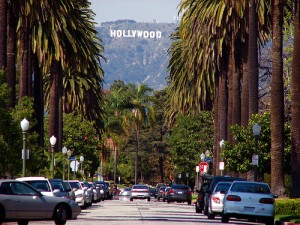 street view of palm trees and the hollywood sign on the hillside