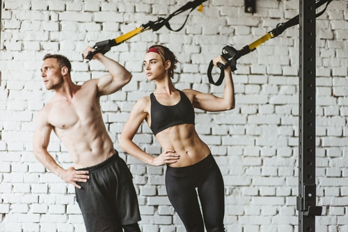 Fit man and woman exercising