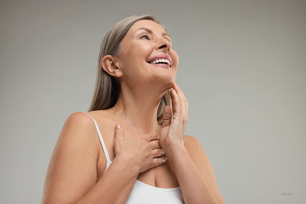 Mature woman touching her face